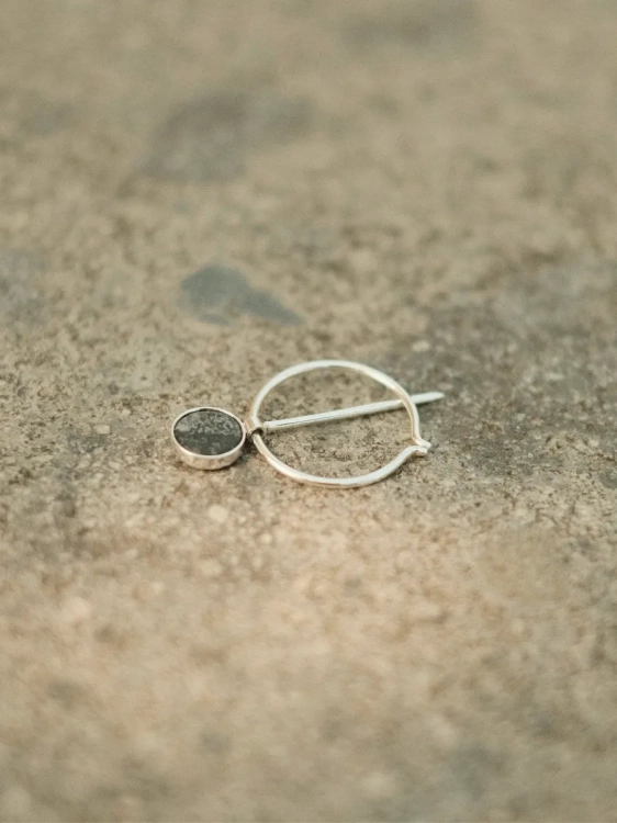 Minimalist silver brooch with circle and natural black stone