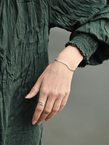Sterling silver wave bracelet worn on the wrist