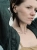 Silver wave earrings with milky amber worn on the ear