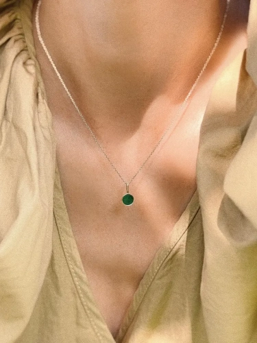 Short sterling silver necklace with natural green nephrite worn on neck