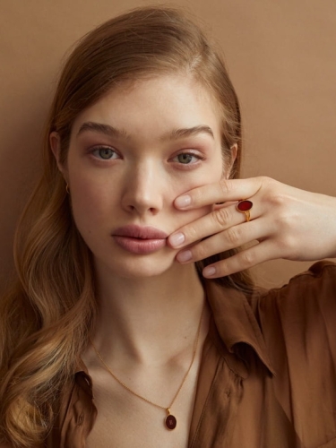 Gold-plated Baltic amber ring worn on the hand
